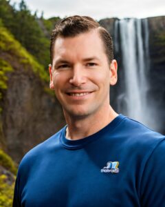 Neil Colvin at a waterfall, explaining what to look for when searching for a marketing agency near me.