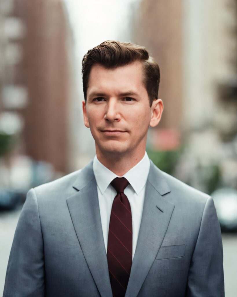 How To Claim Business Page On Facebook explained by Neil Colvin, CEO of Columbus Marketing Experts while downtown in a grey suit and black tie.